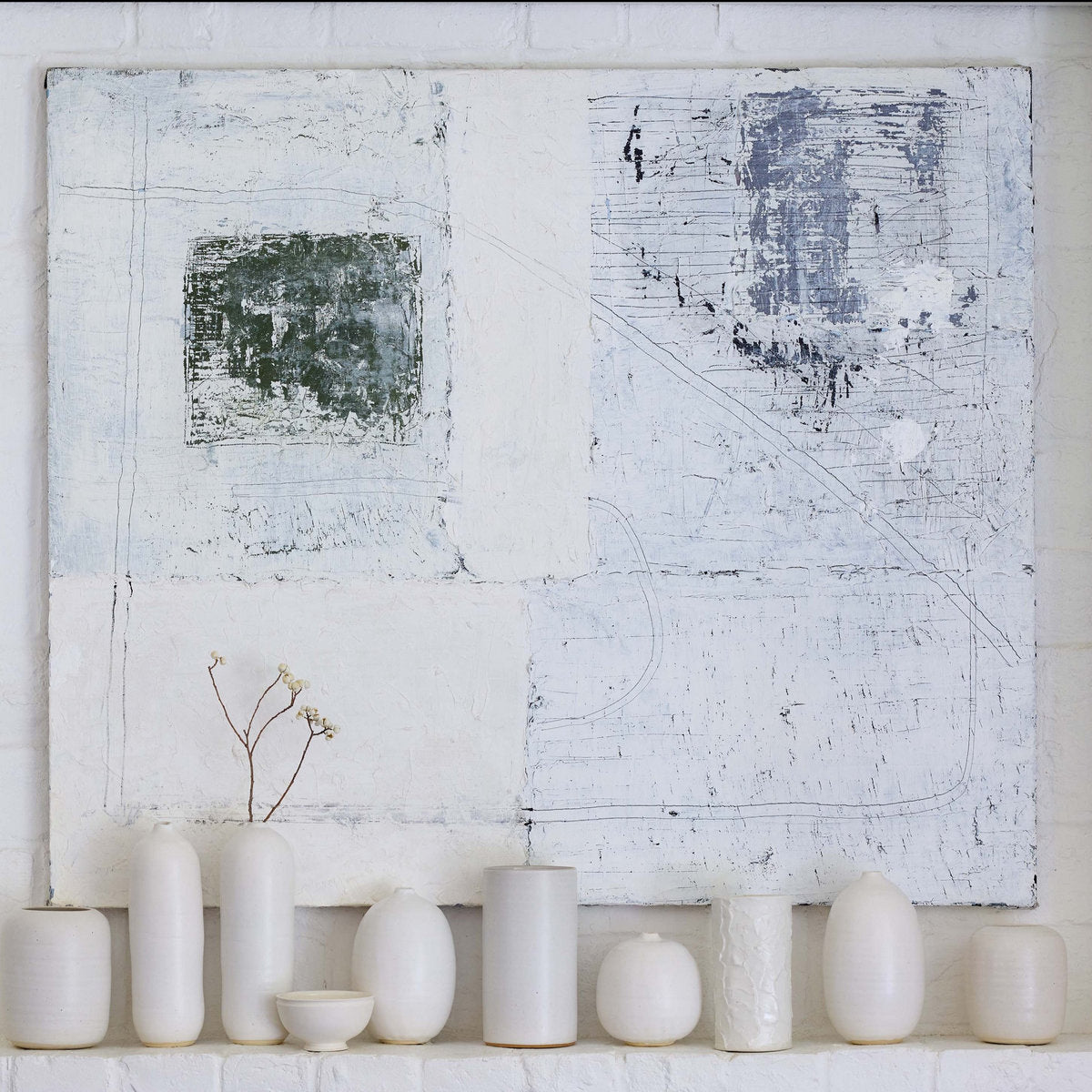 White stoneware vases on a shelf