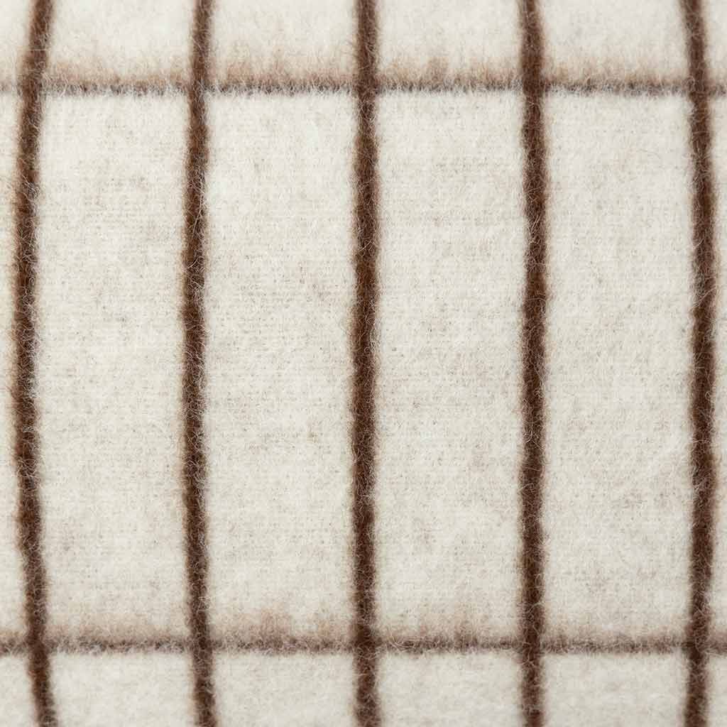 Aalto tan throw pillow showing sepia grid lines drawn from raw alpaca fleece
