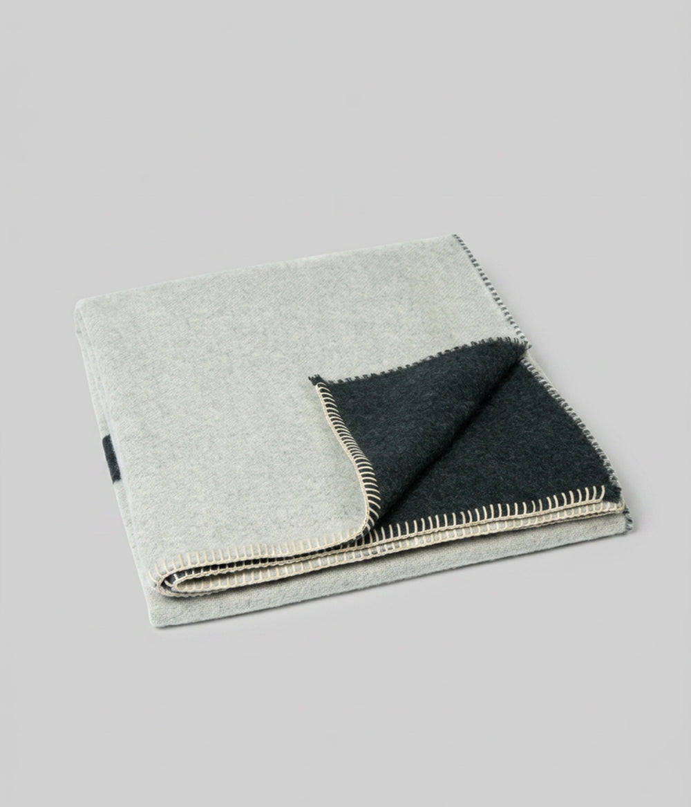 Berlin throw Darkest Spruce Bone showing both faces at folded corner