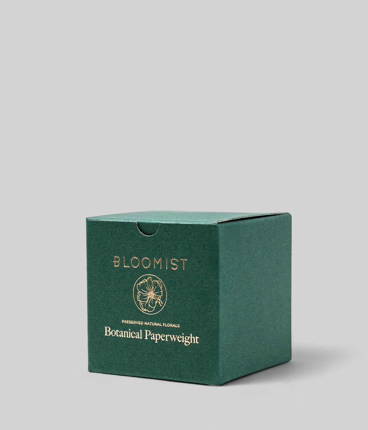 Green Bloomist box for the botanical glass paperweight, shown on a neutral grey background