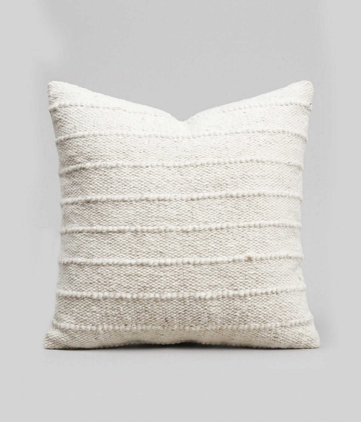 Square boho pillow woven from 100% undyed wool