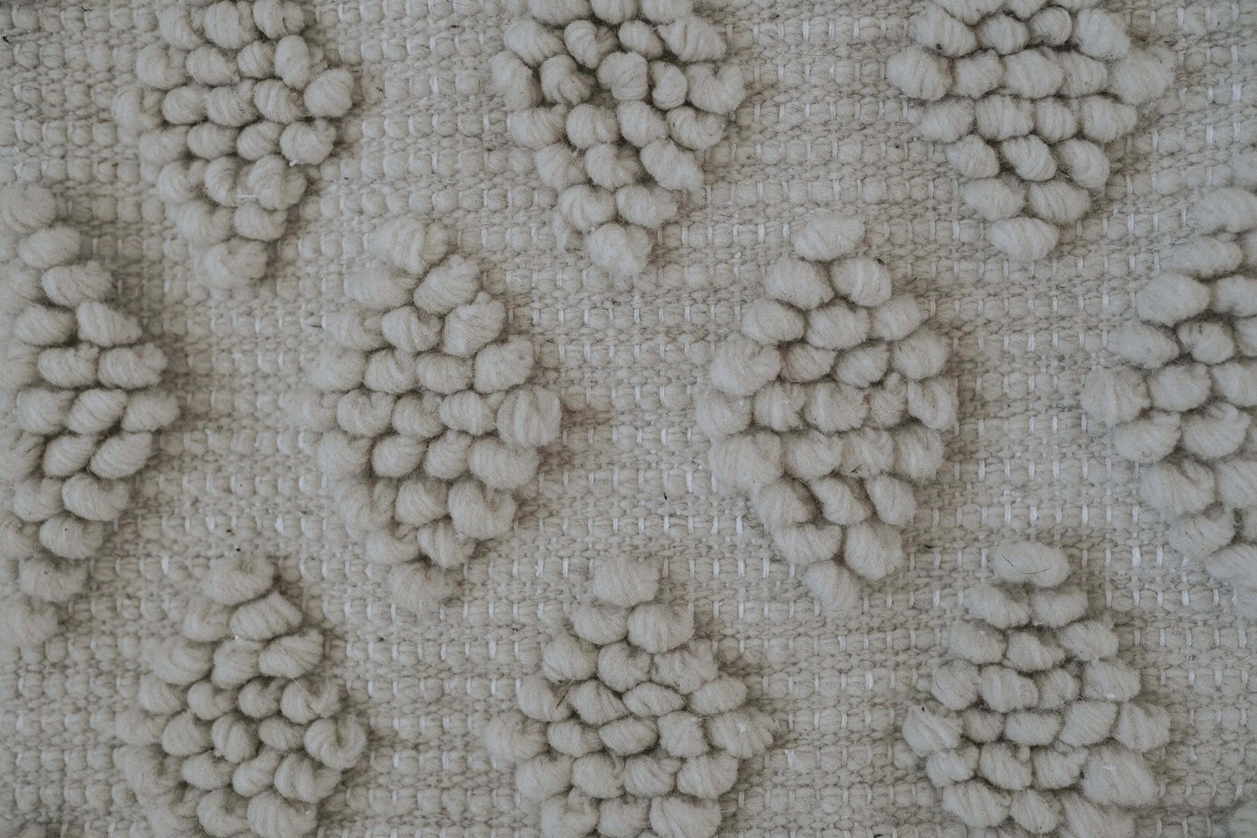 Neutral throw pillows made from 100% undyed natural wool