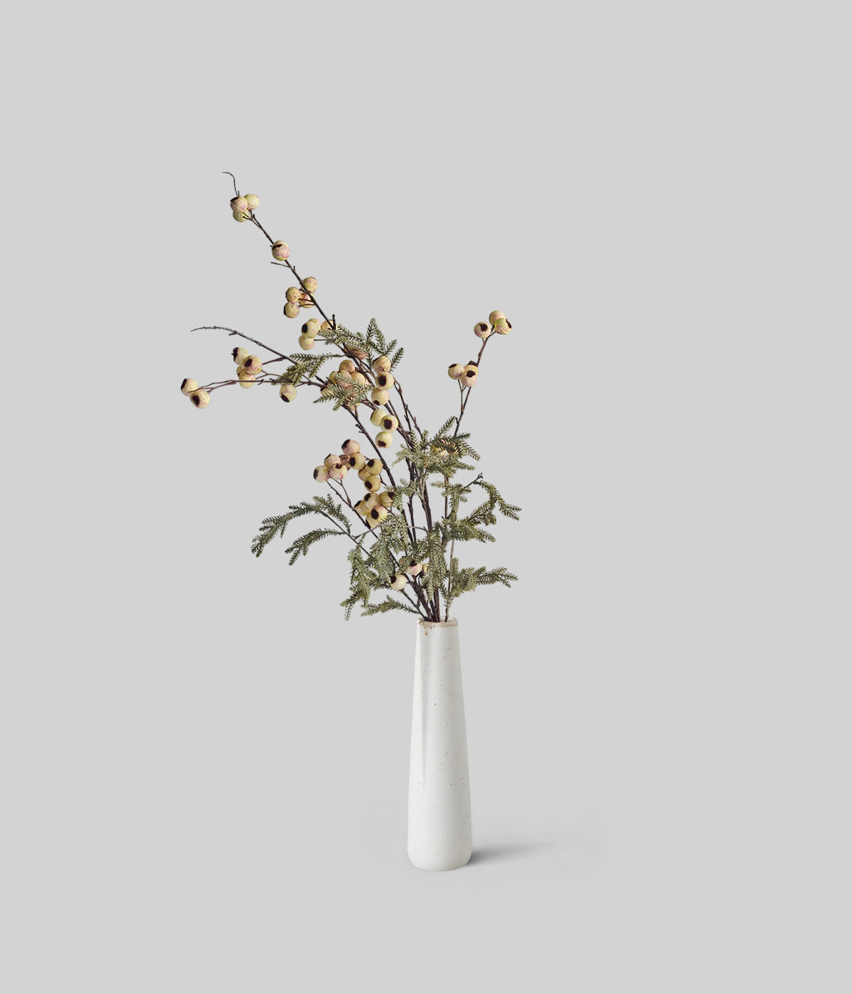 Frosted pine and cream hawthorn berries in lifelike artificial bouquet