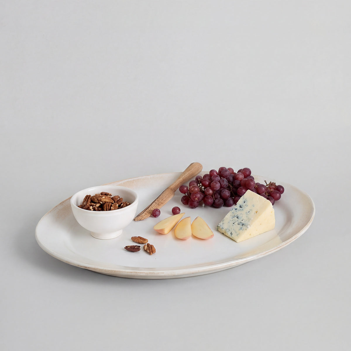 Farmhouse serving platter with wide oval surface for serving