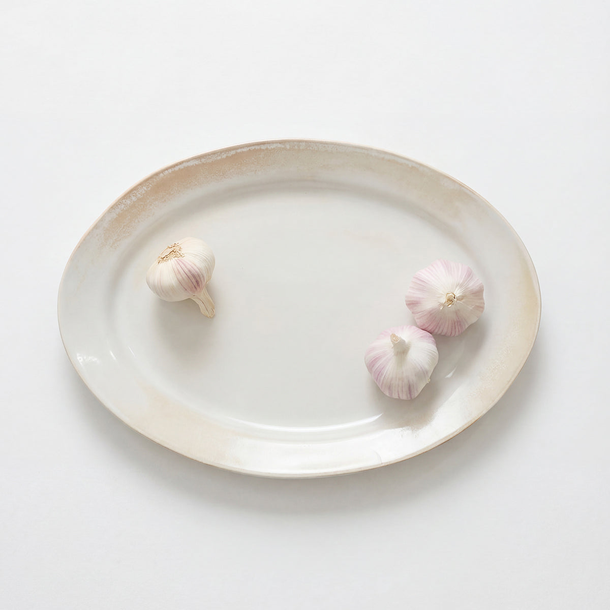 Rustic serving platter with warm tonal variation from firing