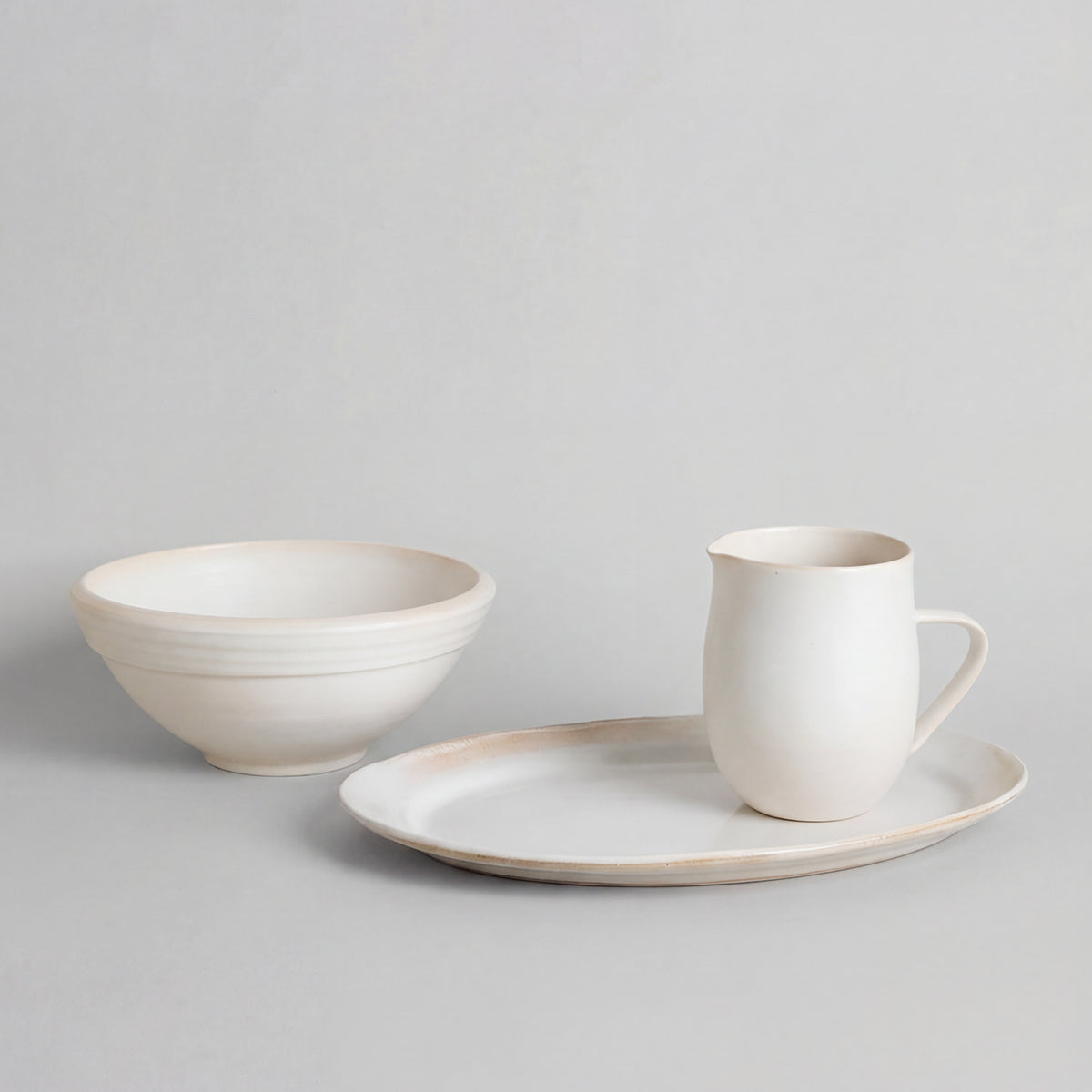 Oval ceramic platter styled with food on dining table
