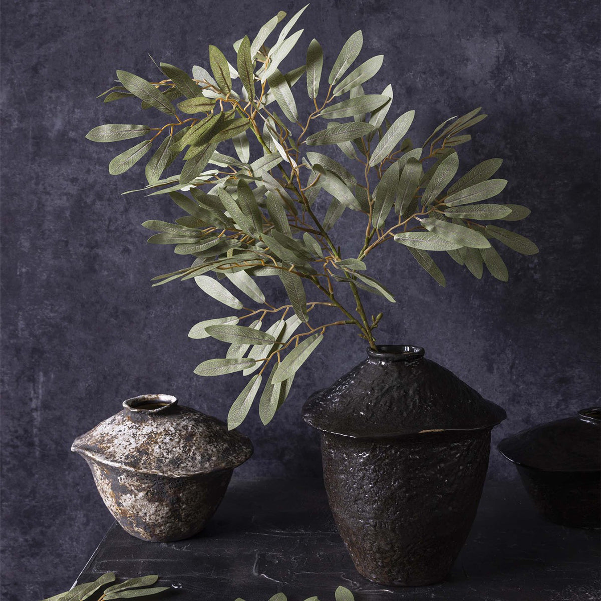 Faux Willow Branches styled in a tall black vase for sculptural decor