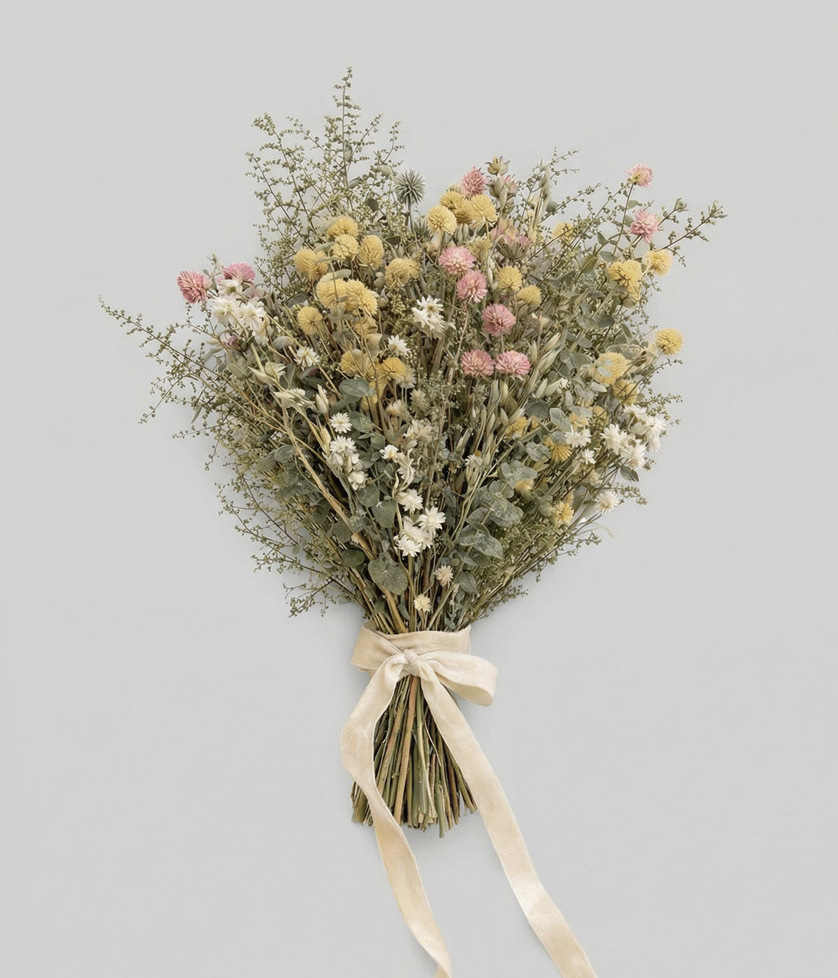 Neutral flower arrangement with blush and ivory globe amaranth tied with ribbon