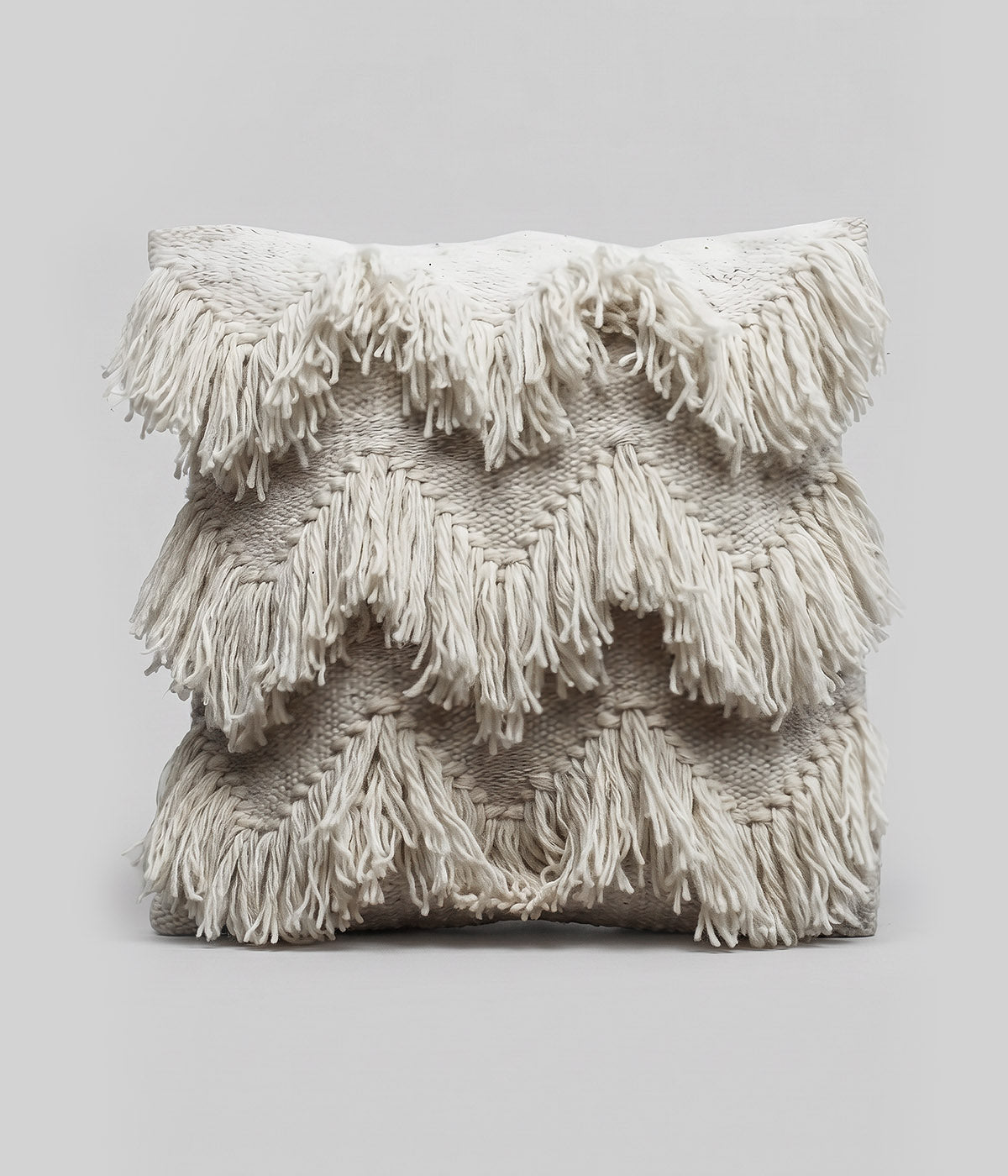 Woven pillow with long free-hanging fringe strands