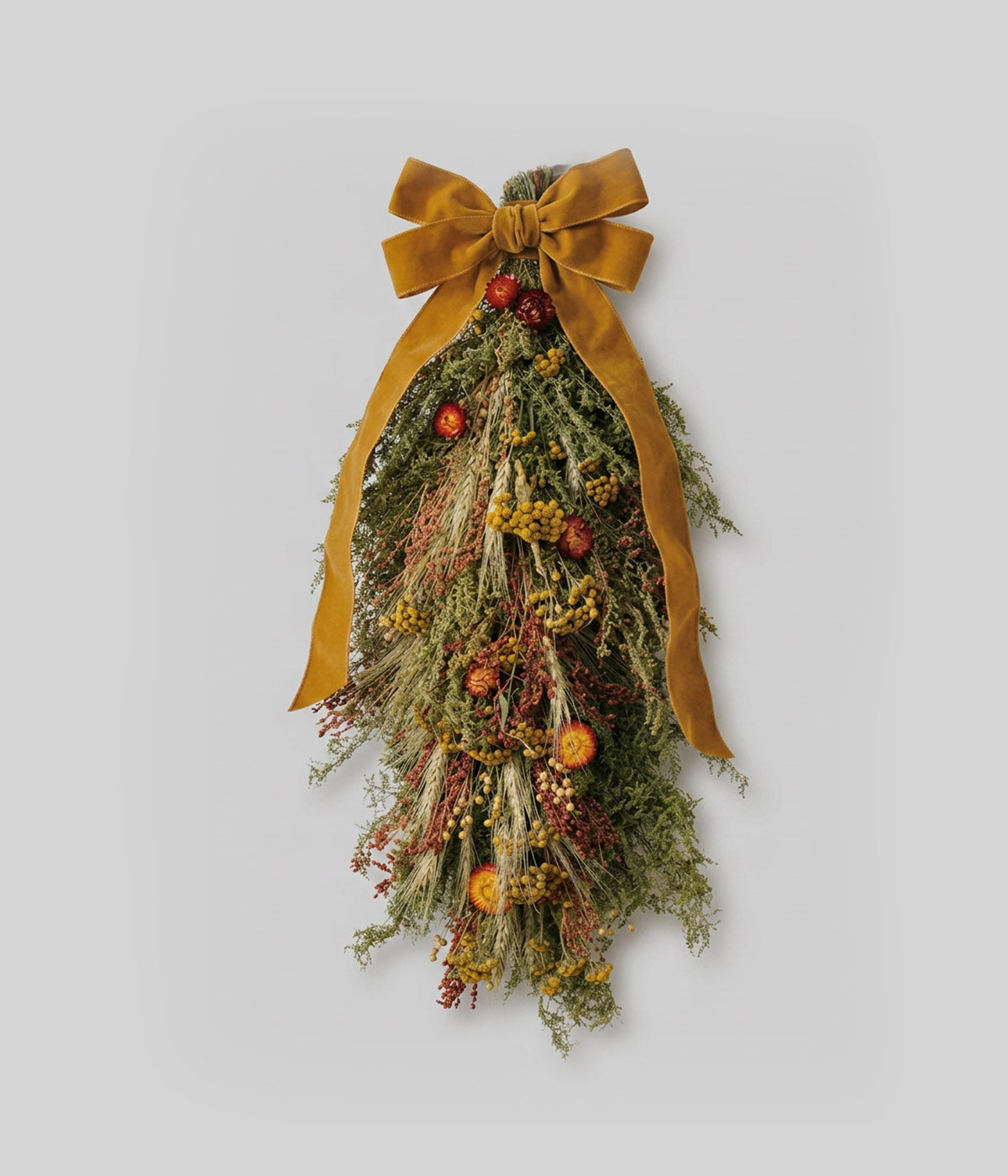 Dried floral swag with tansy, strawflowers, and a velvet bow