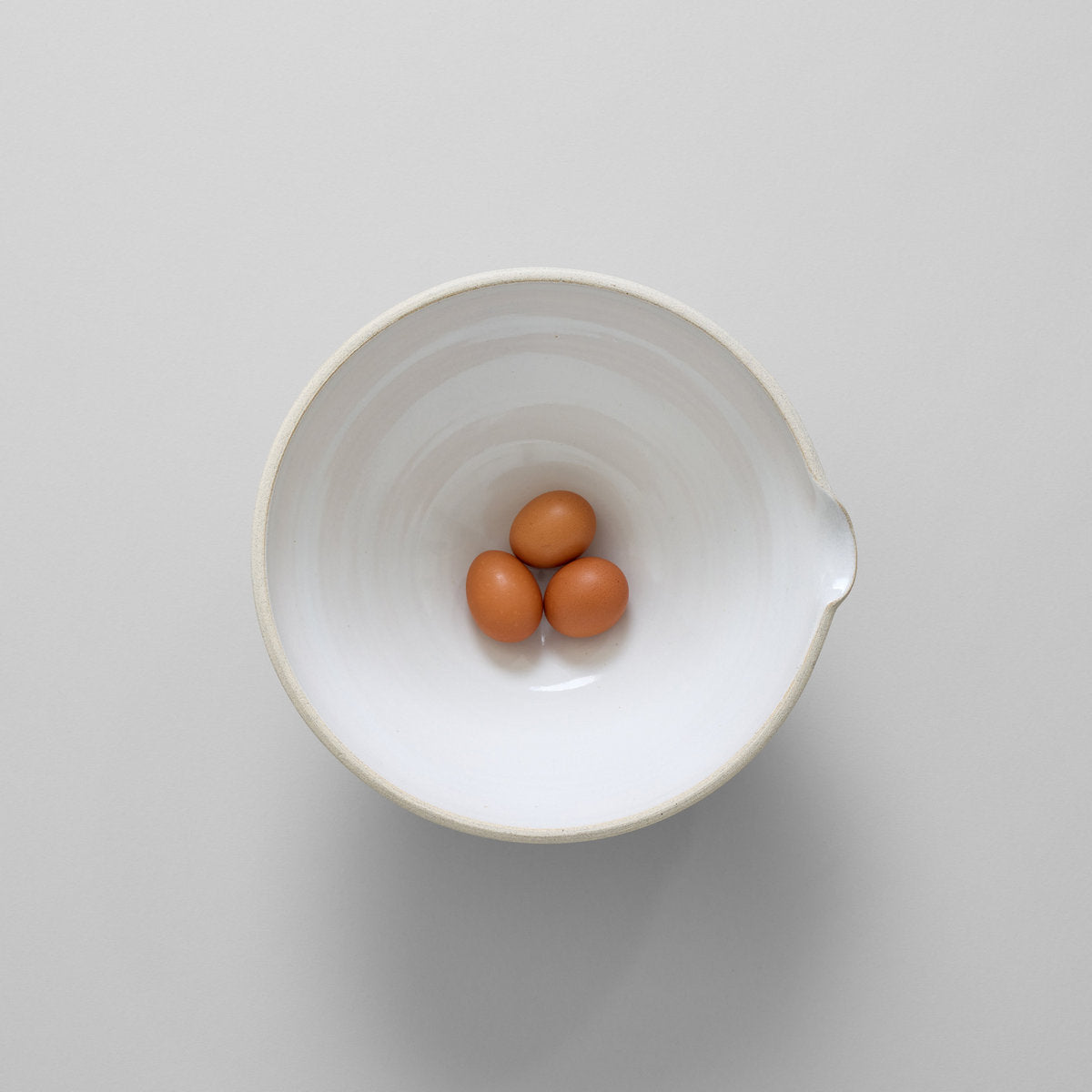 Large pottery mixing bowl with glazed interior and raw exterior