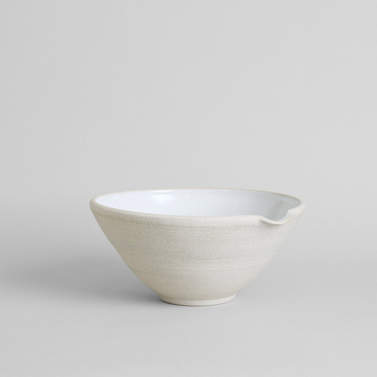 Ceramic mixing bowl with wide rim and pour spout in granite clay