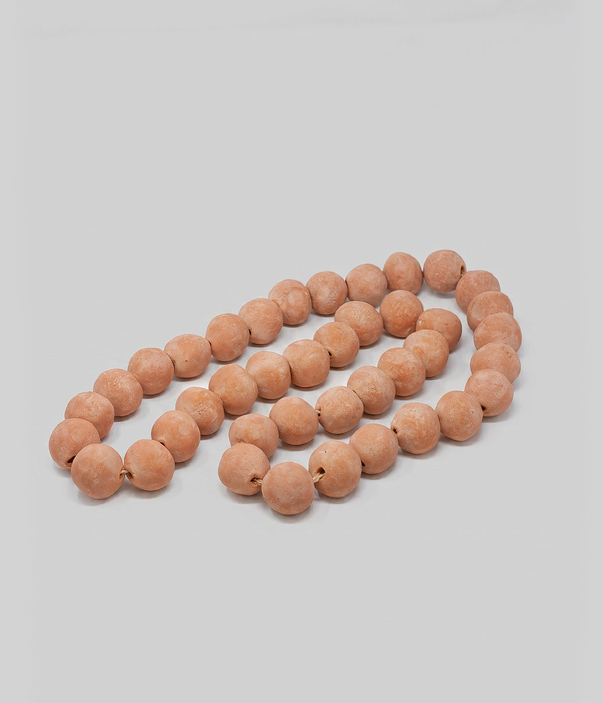 Terracotta beads strung on cord for decorative styling