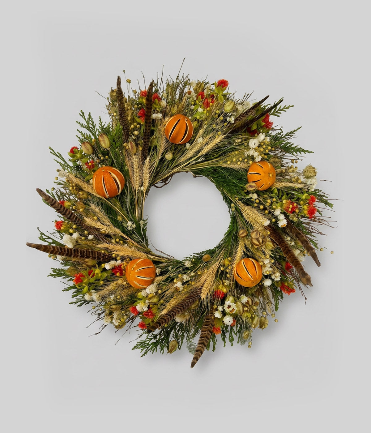 Dried citrus wreath with dried oranges, pheasant feathers, wheat, cedar, and twig