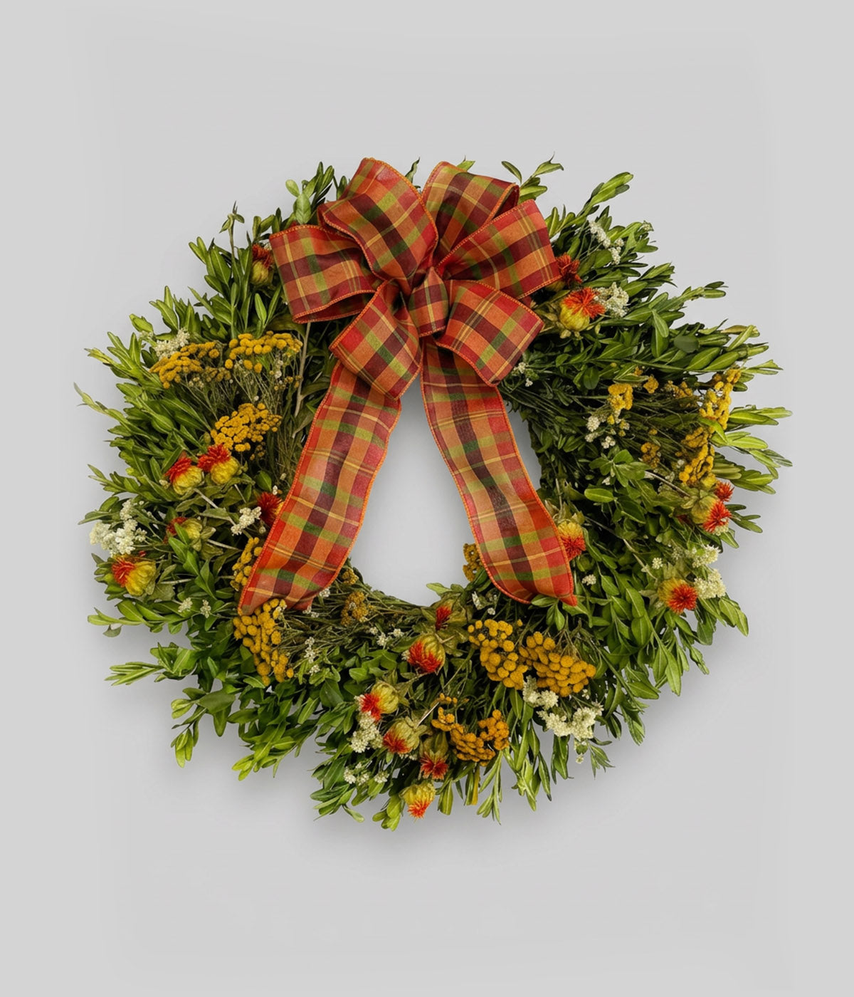 Boxwood wreath with tansy, safflower, and a plaid harvest bow