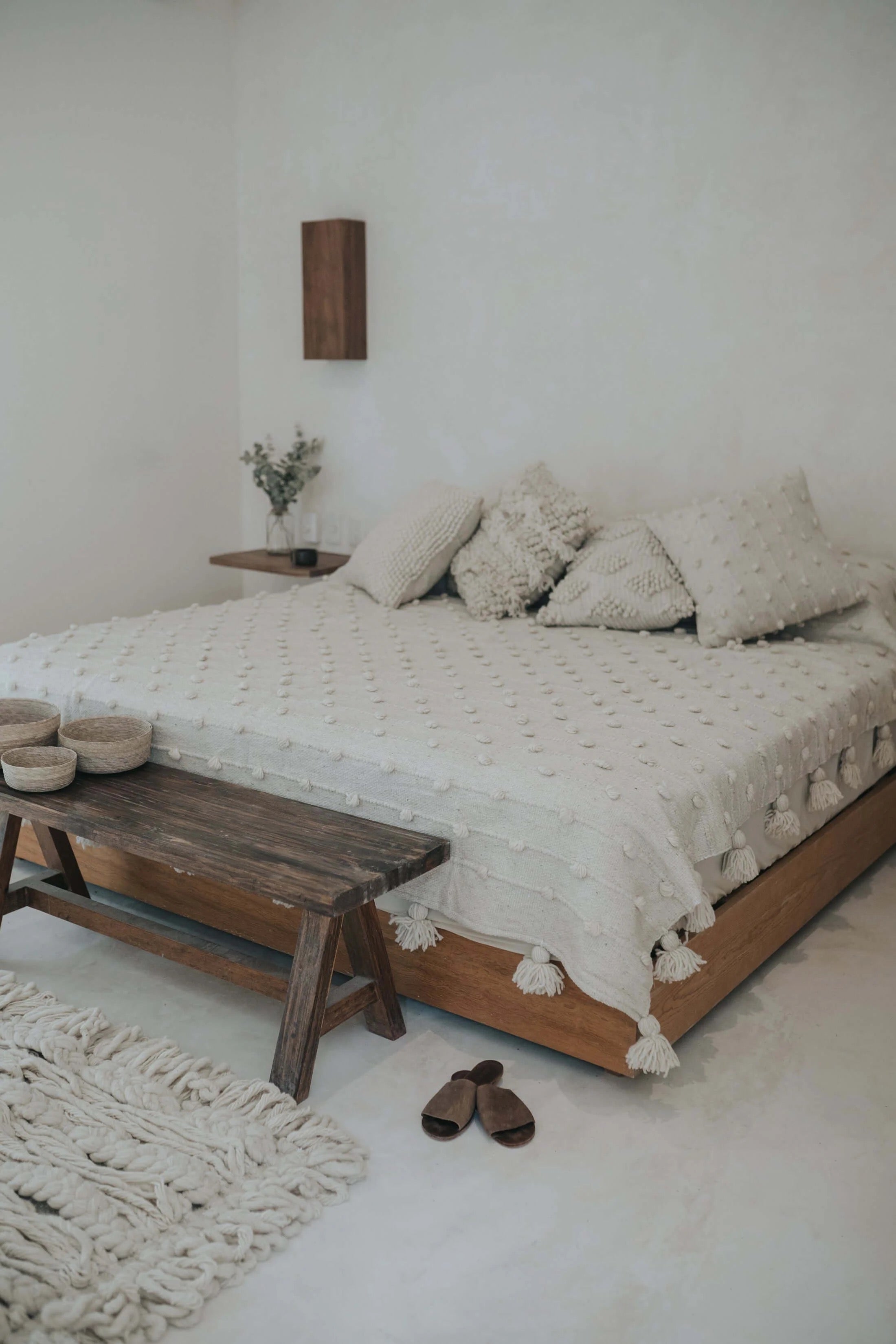 Soft wool blanket with individually placed pompom dots and tassels
