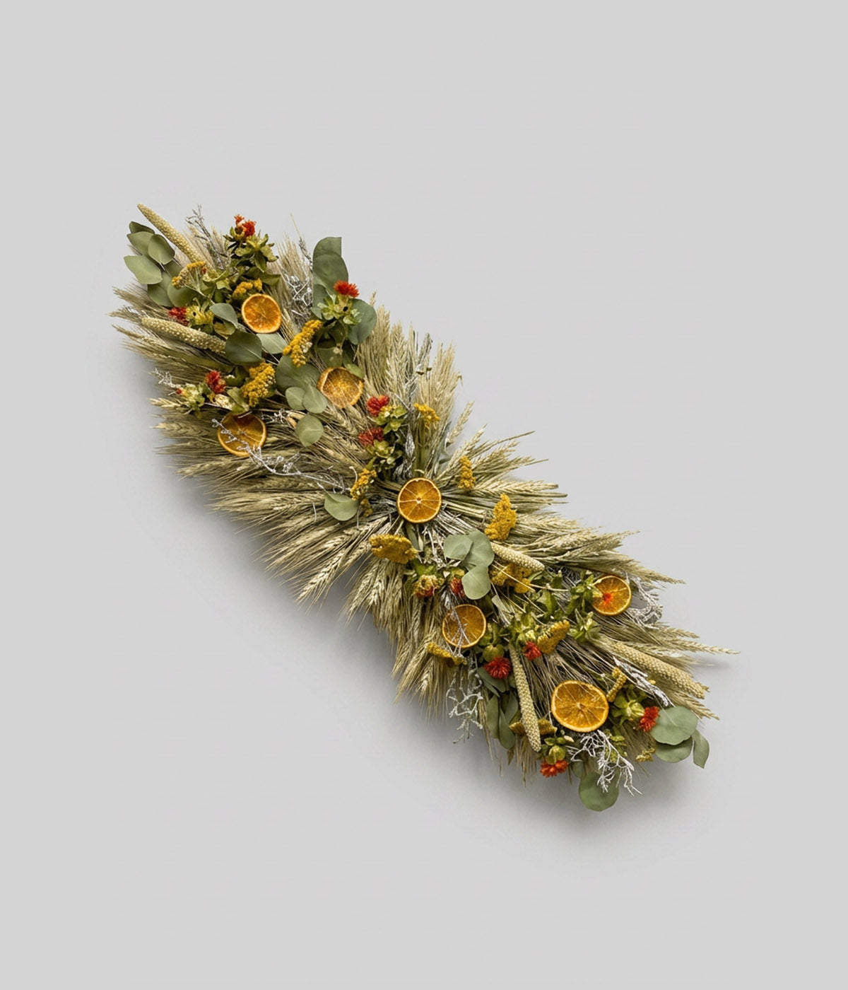 Dried flower centerpiece with citrus, wheat, and eucalyptus