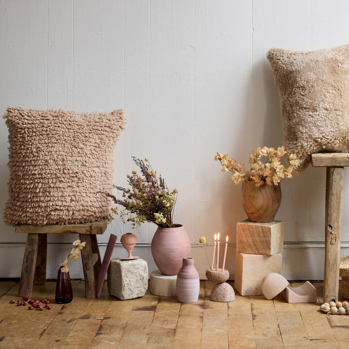 Pink bud vase made from terracotta clay styled with dried stems