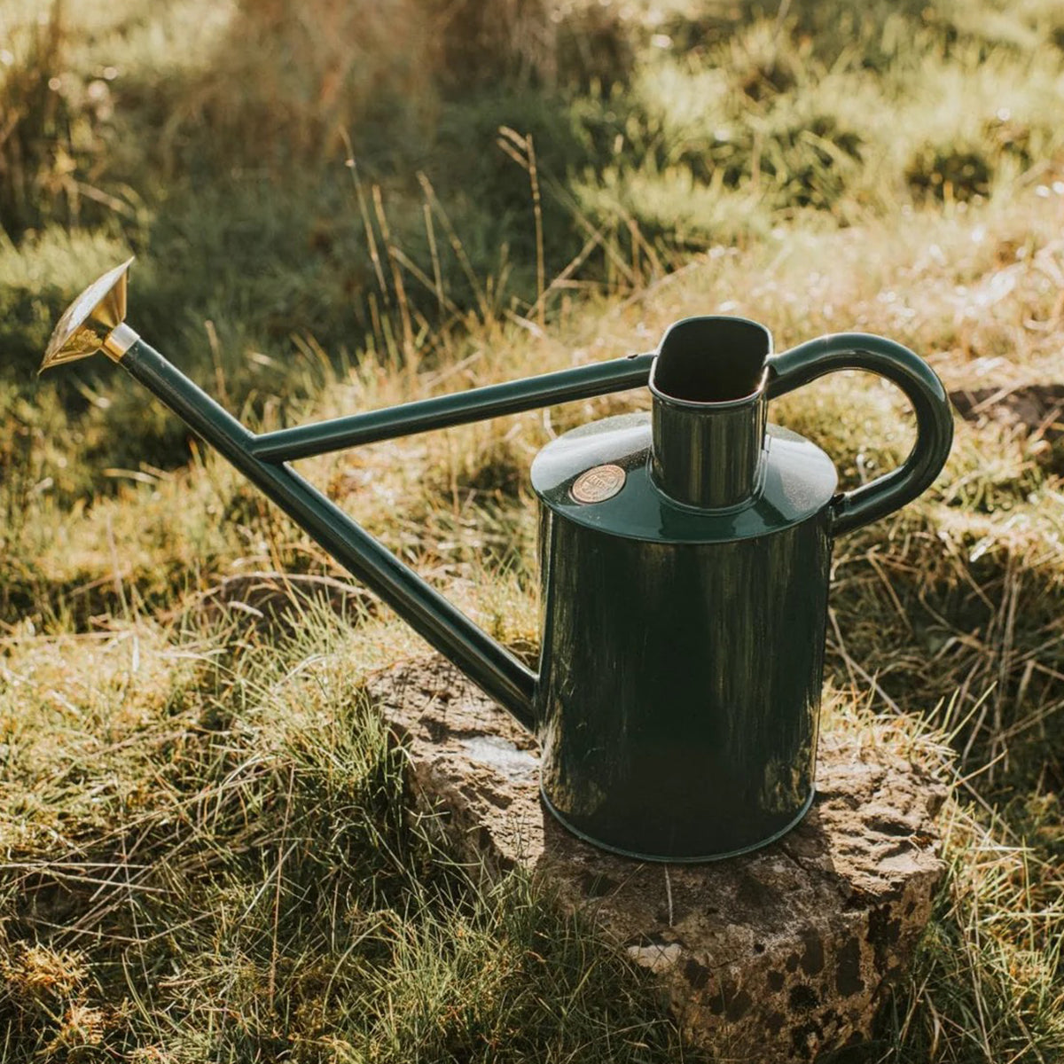 Fancy watering can made by Haws with elegant silhouette and fine brass rose attachment