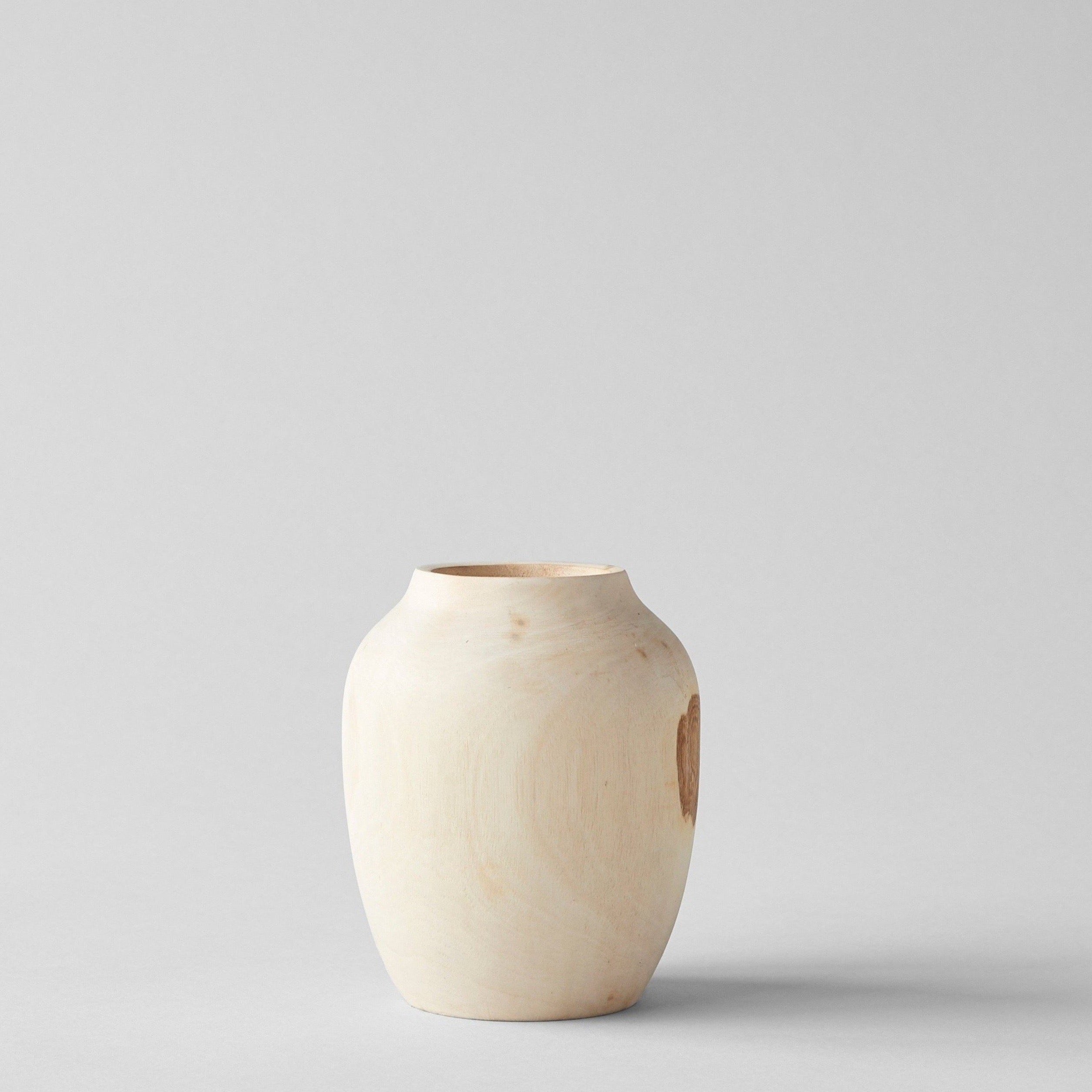 Hand-carved walnut wood vase with rounded plum shape