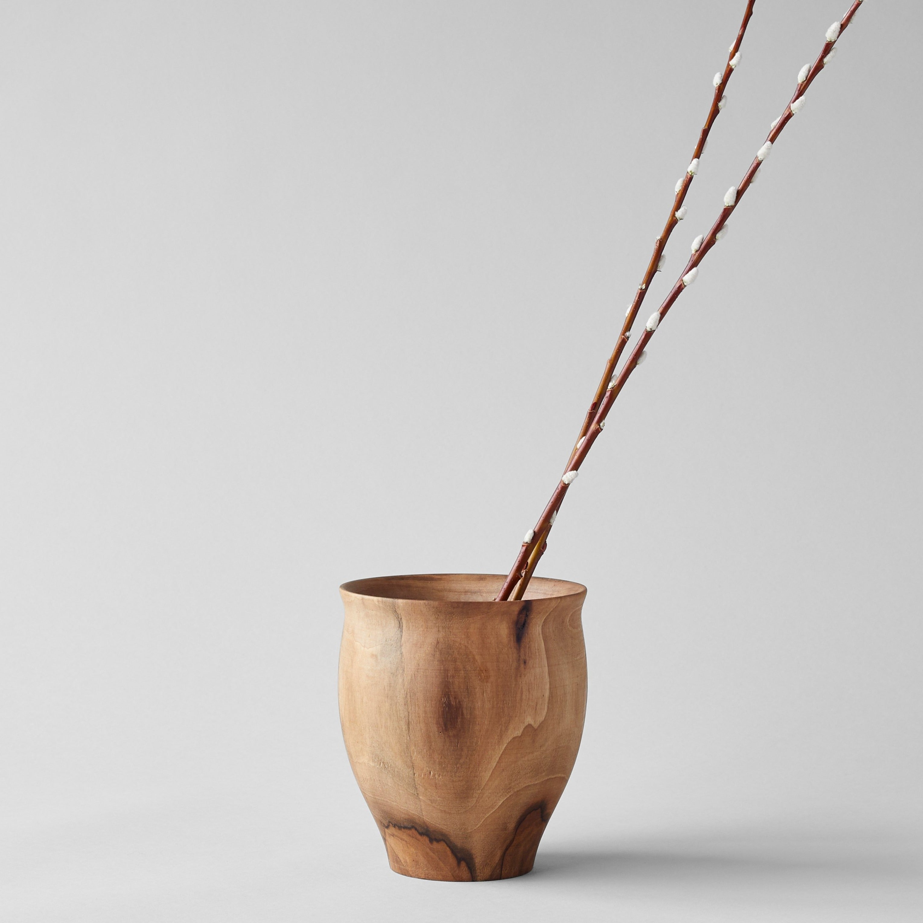 Artisan-carved dark walnut vase with natural knots and grain