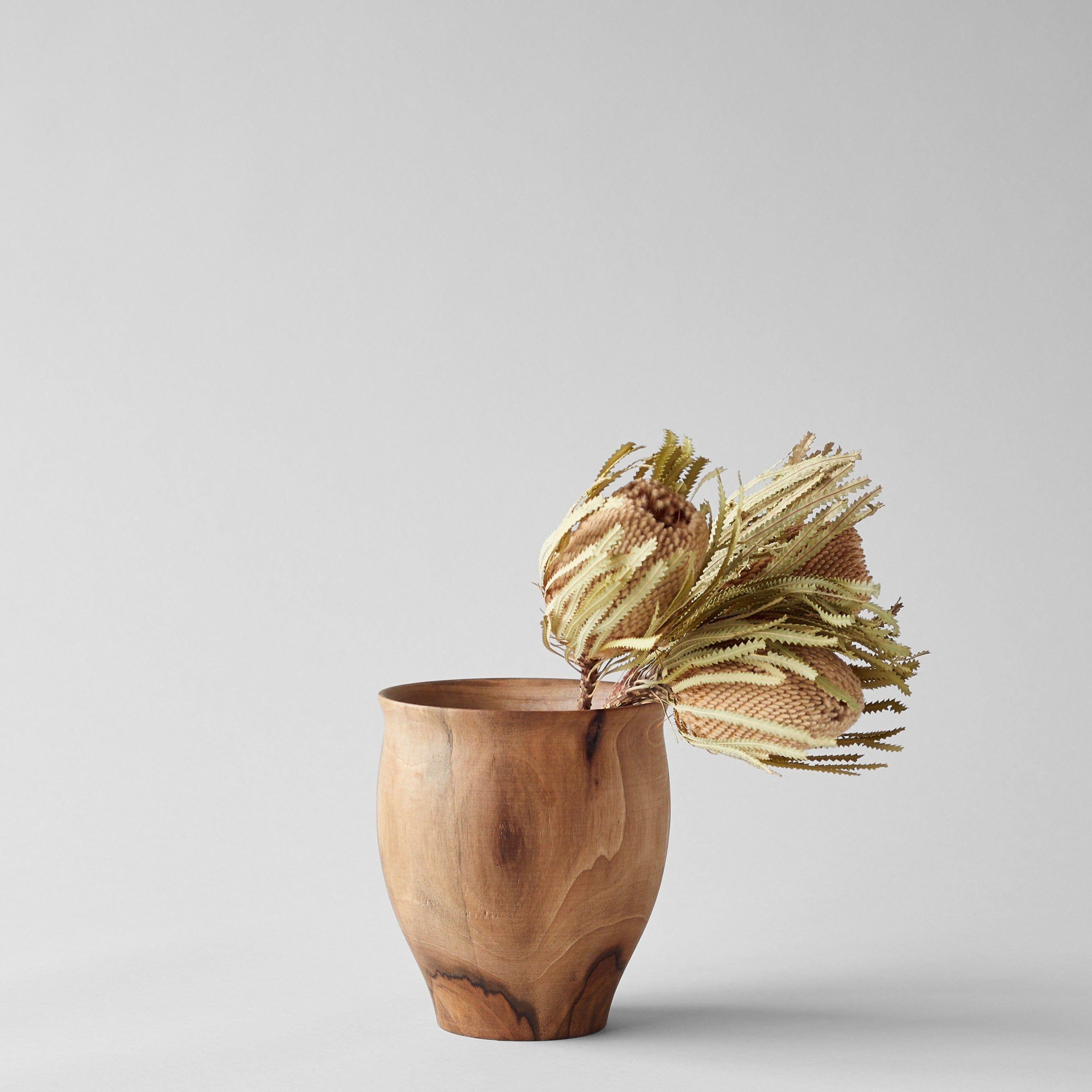Dark walnut bell vase with natural wood grain