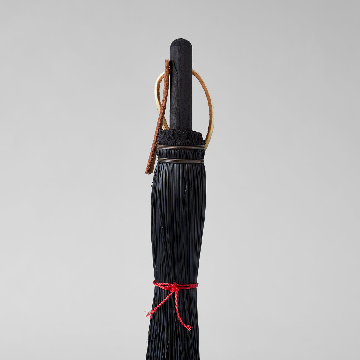 Handheld broom for cleaning fireplaces, desks, and potting areas
