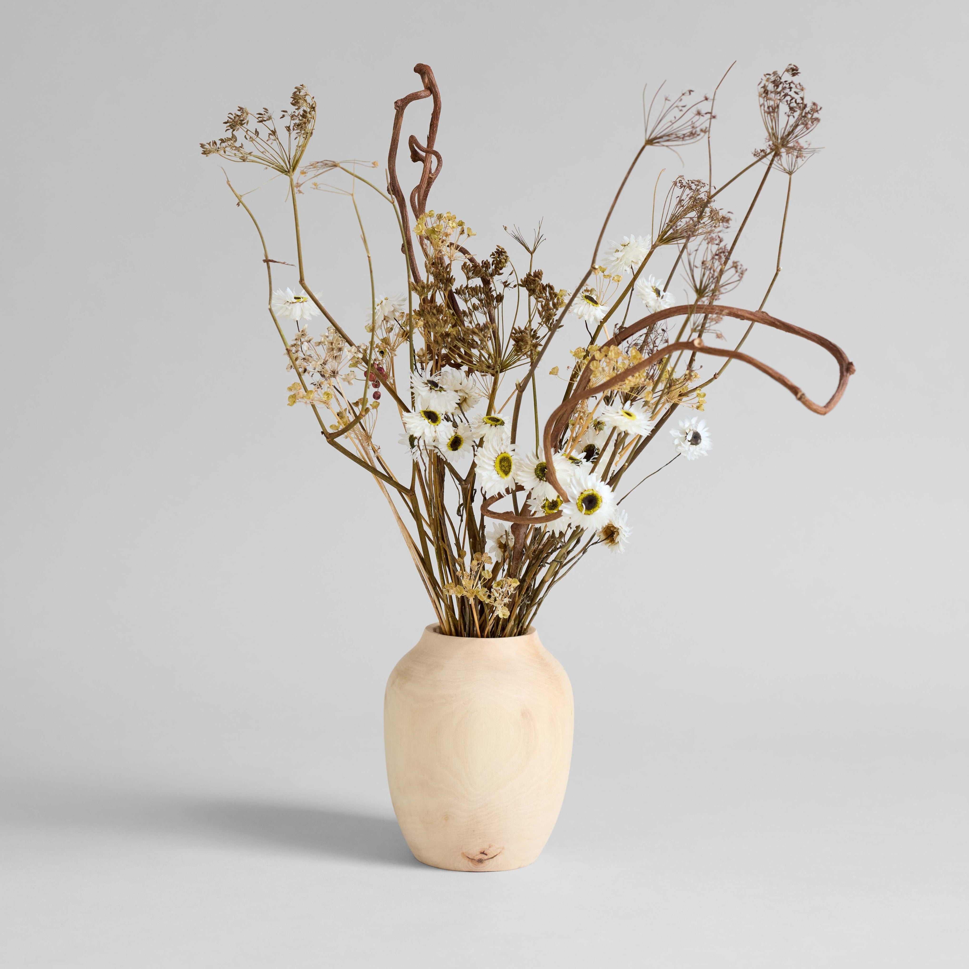 Handcrafted carved wood vase with natural grain and knots