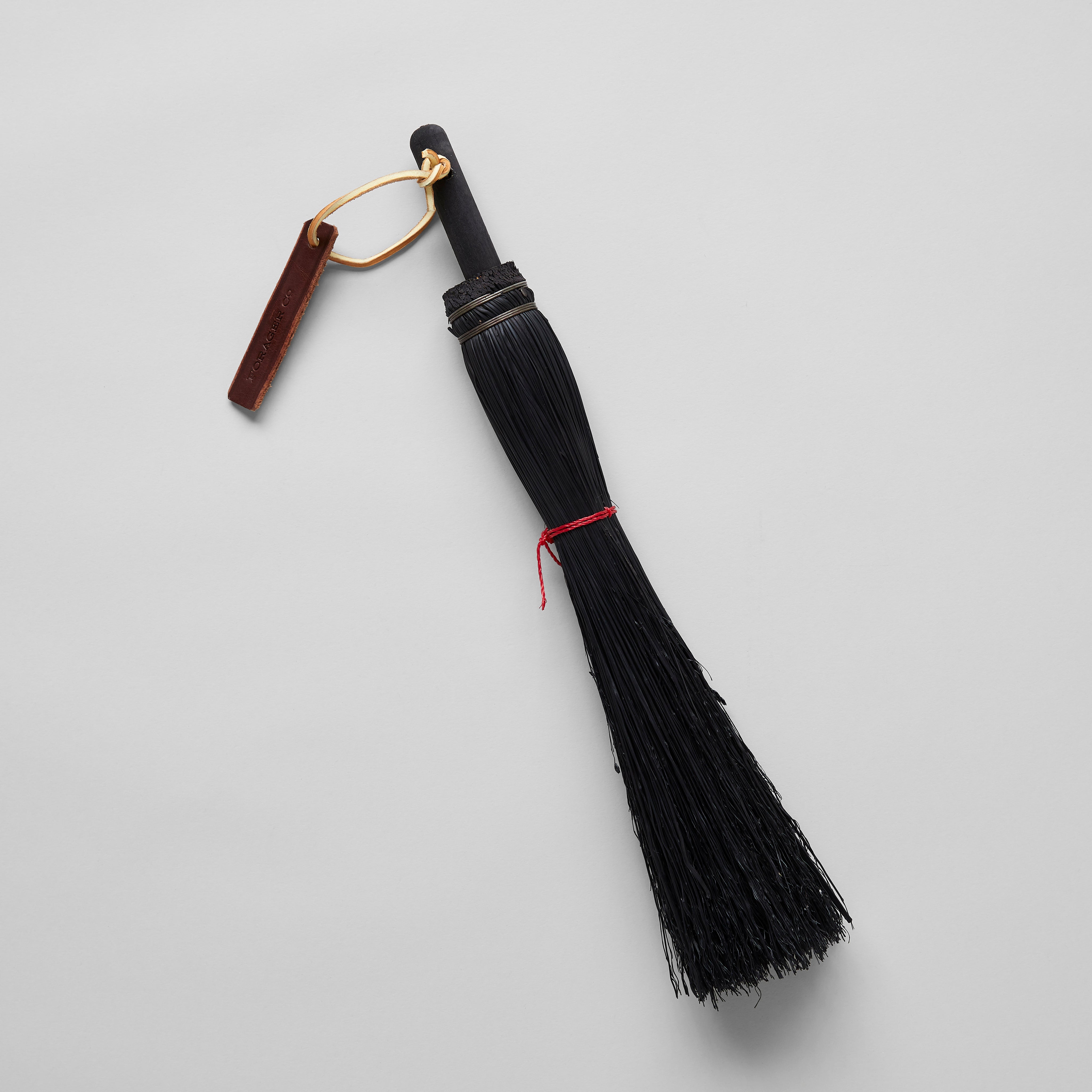 Hearth broom with natural fiber bristles and handcrafted wood handle