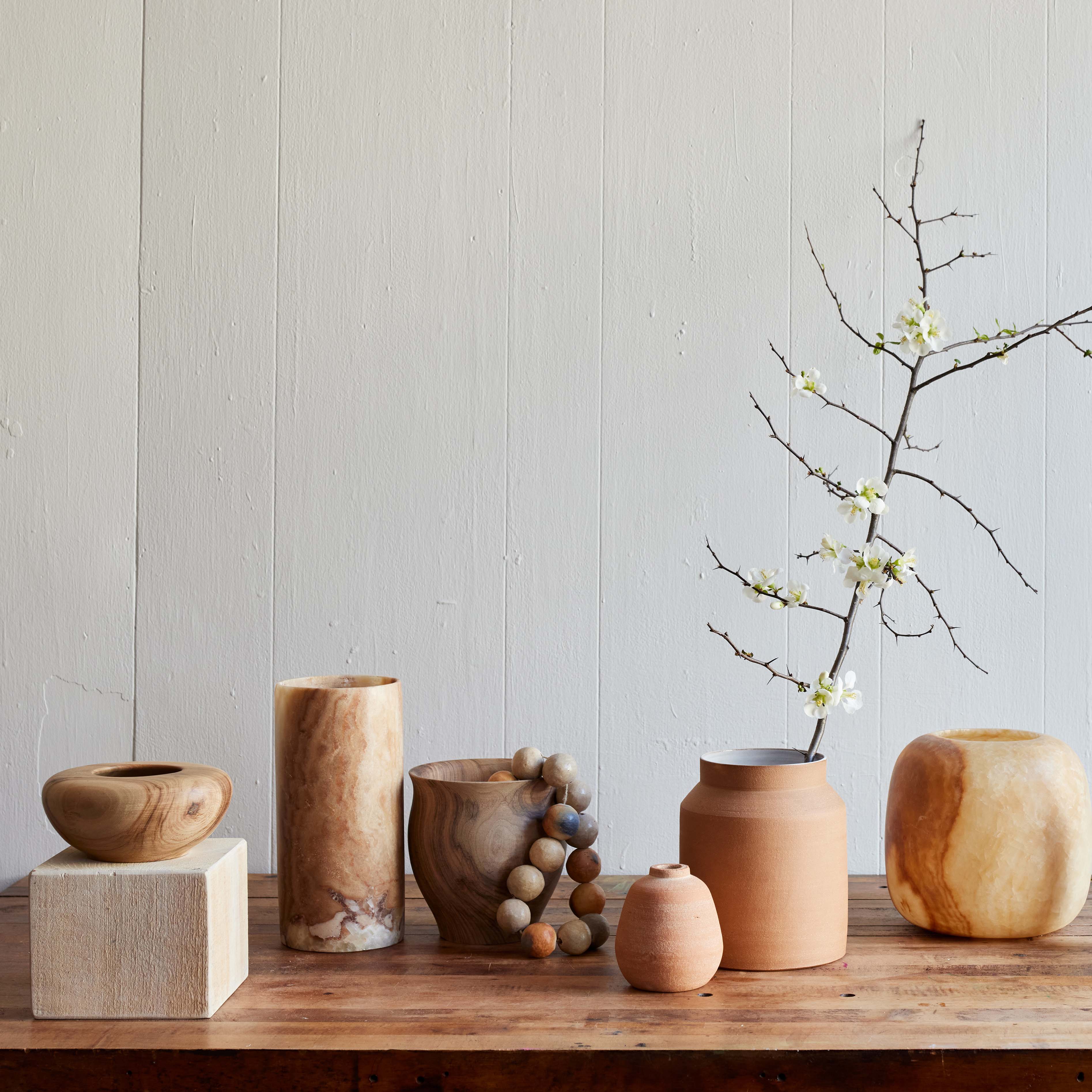 Large wooden bell vase styled with dried botanical stems