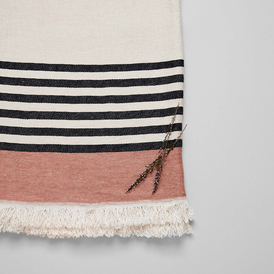 Soft blush and black striped linen throw perfect for guest bed or sunroom decor
