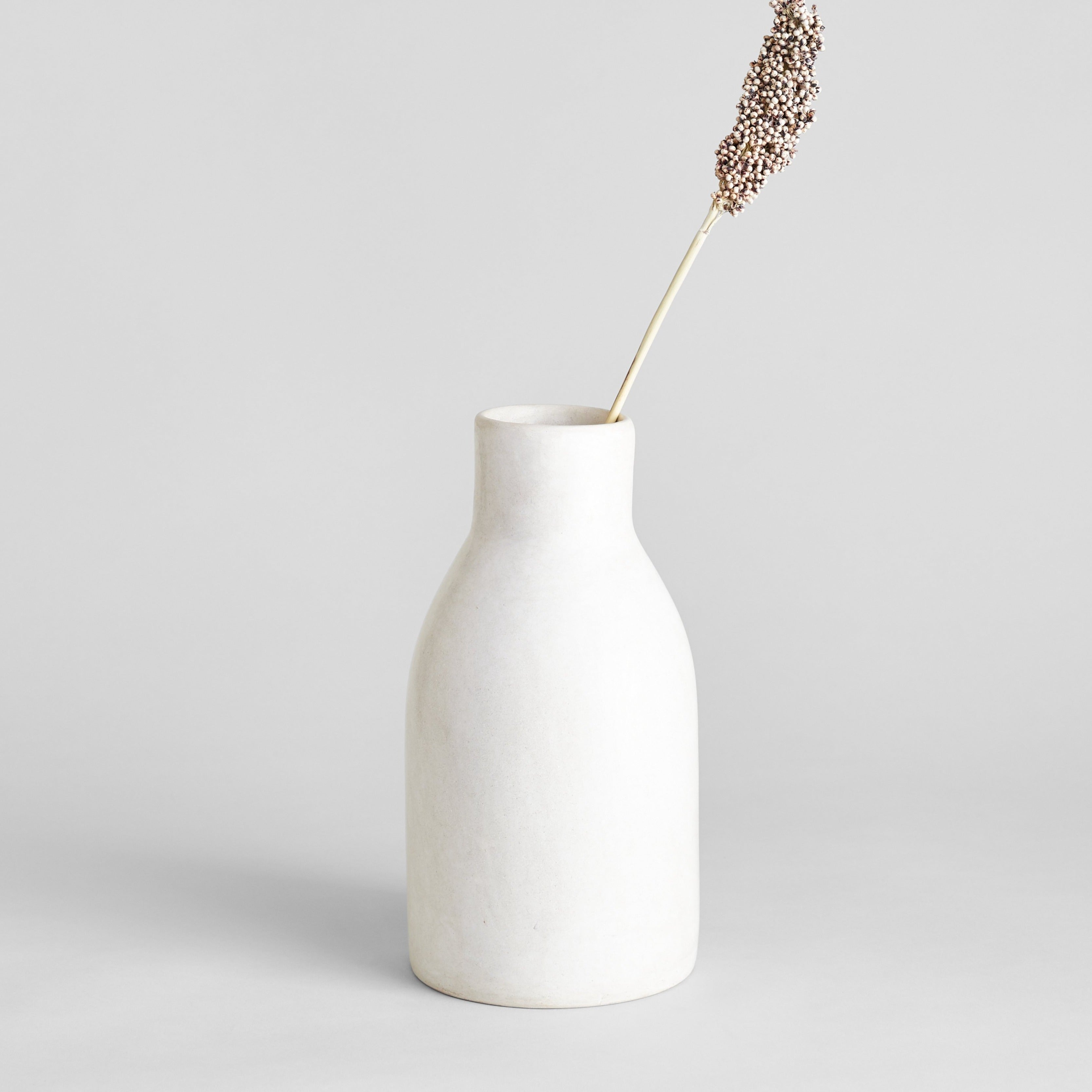 Ivory Moroccan clay vase styled with dried stems